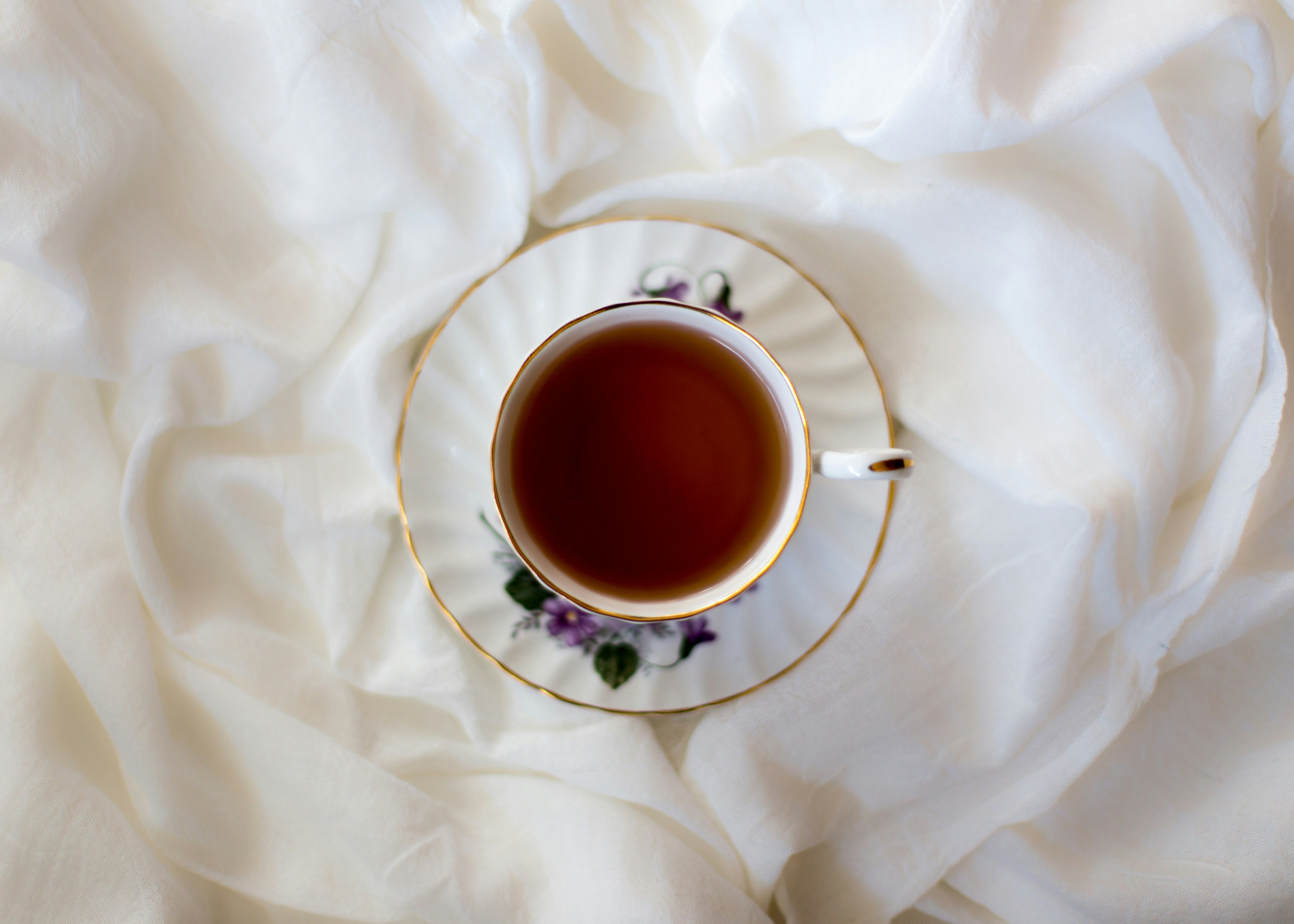 Elegant tea cup on white fabric